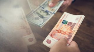 Hand holding US dollar bills trading with Indian Rupee - foreign money conversion and exchanging concept